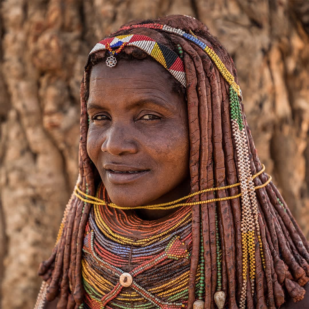 Woman in traditional beadwork and ochre hairstyle