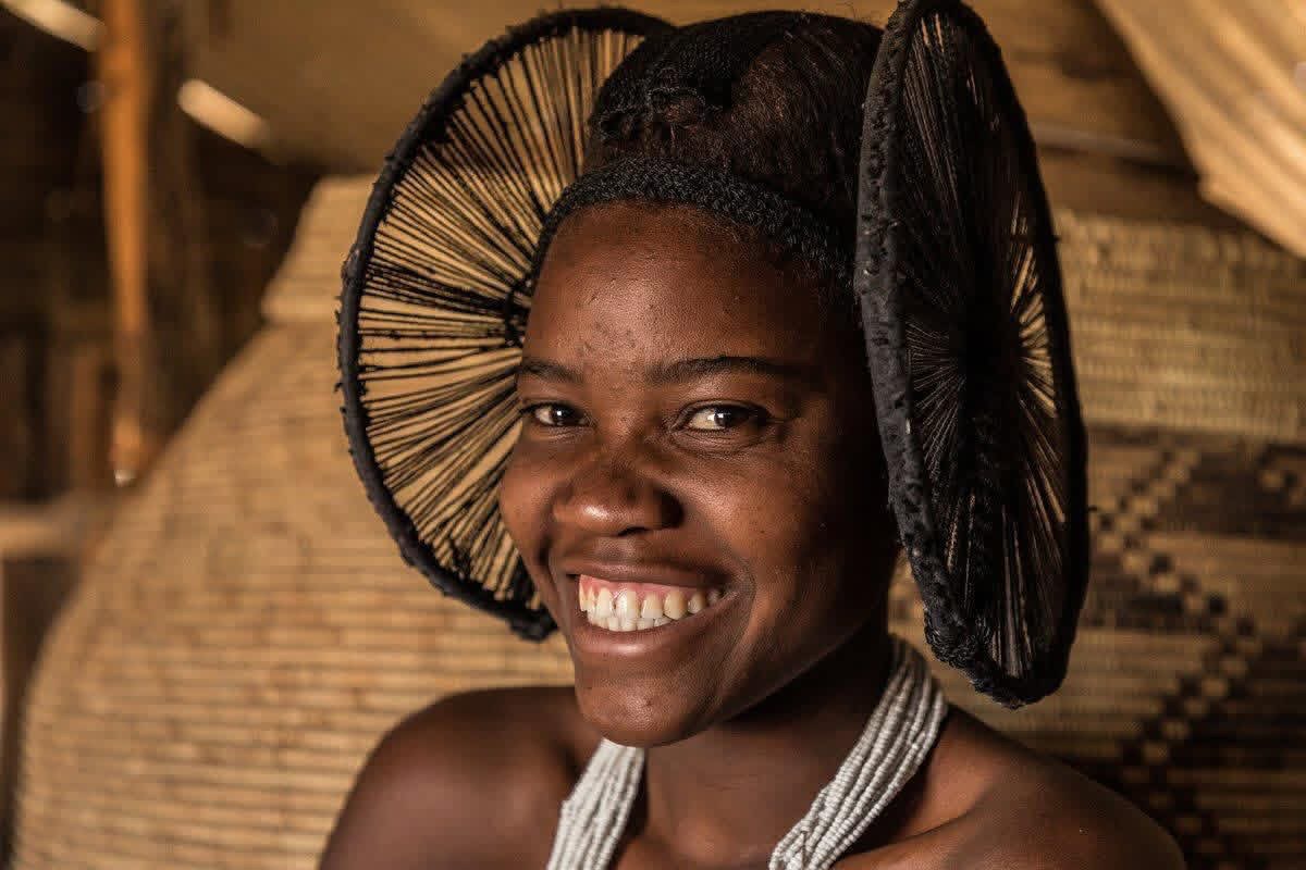 Smiling woman in a woven headpiece