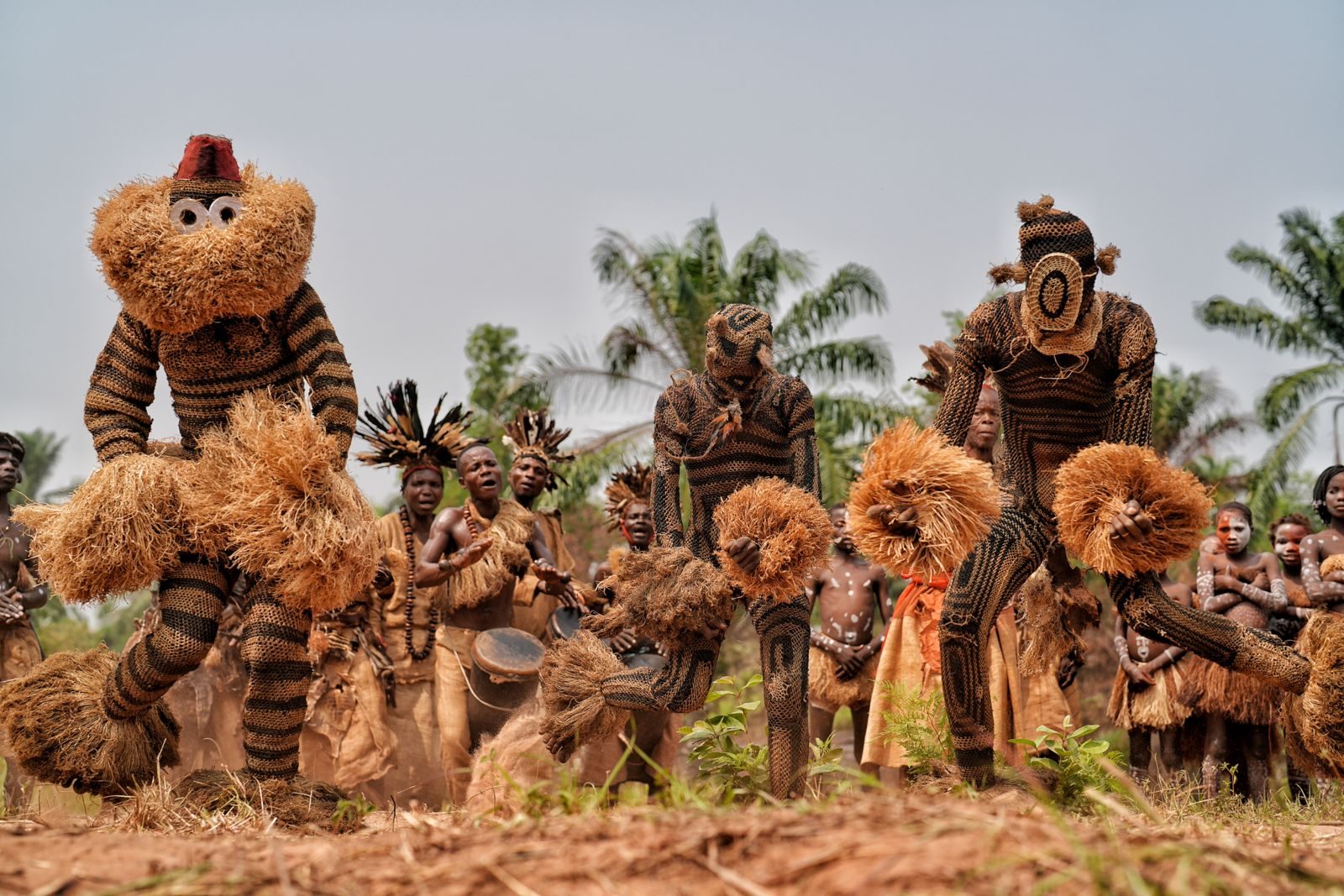 Straw-costumed dancers in a clearing