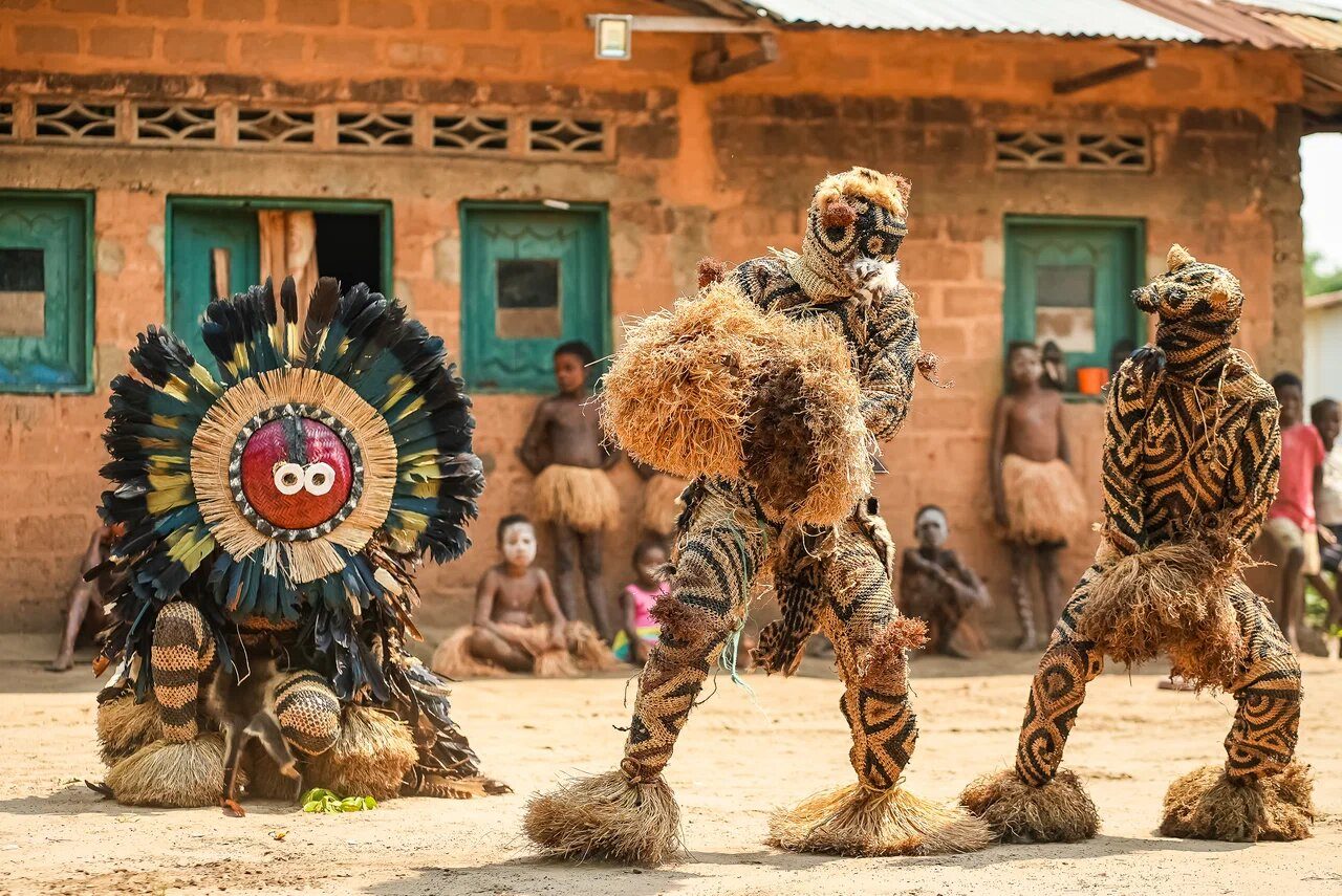 Masked dancers outside a house