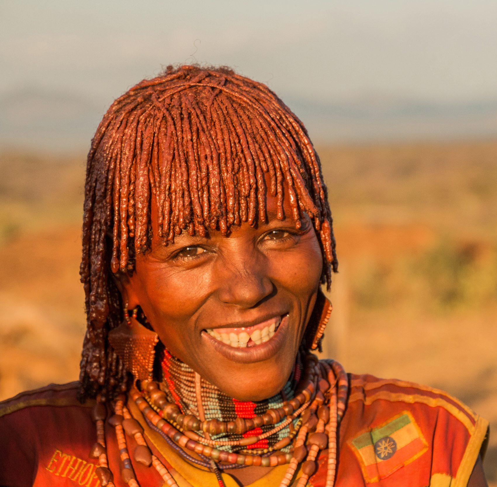 Smiling woman with ochre-coloured hair